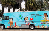 Bookmobile with cartoon images of kids engaging in learning activities