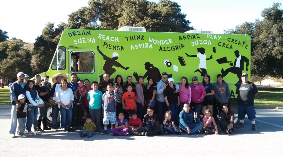 A group of people standing in front of our old bookmobile