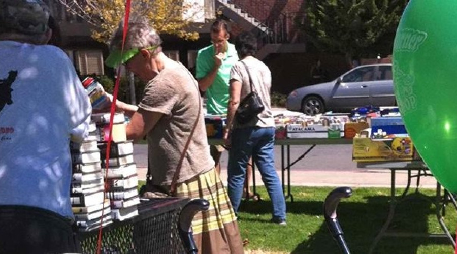 A group of people outside shopping for books