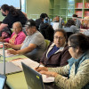 Adults working together on computers