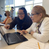 Tutor and student working together on a computer