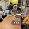 Adult students and staff working on computers in the Literacy Center