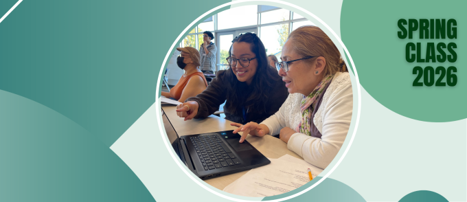 Spring Class 2026 — two women smiling while working together at a computer in a class setting.