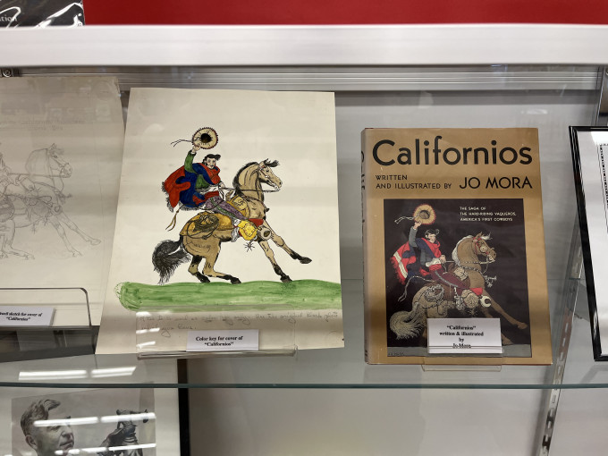 Jo Mora display with his artwork showing a man on a horse
