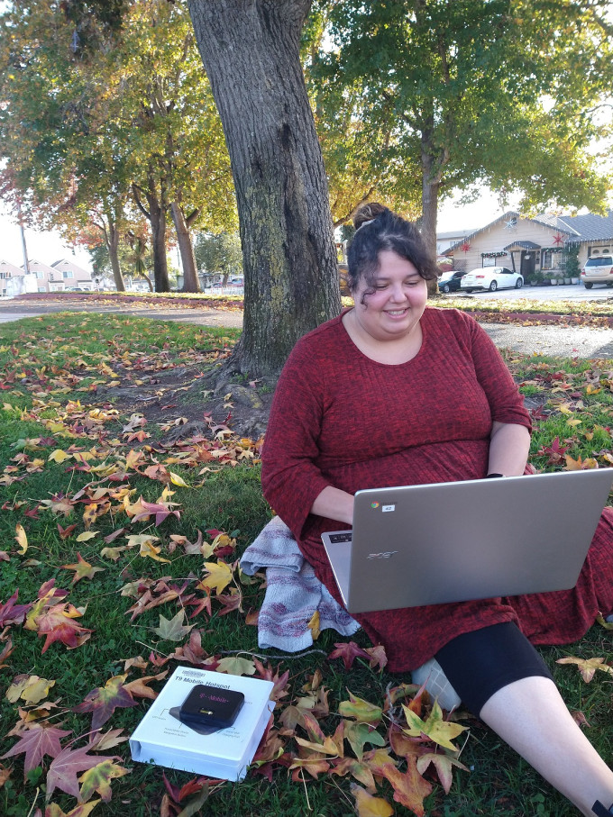 ___KEEP___Woman-sitting-under-tree-with-laptop-and-hotspot-to-access-internet