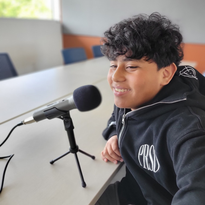 Young teen in front of a microphone.