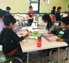 Children practicing writing the alphabet in Kinder Boot Camp.