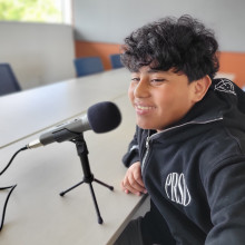 Young teen in front of a microphone.
