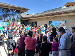 Families gathered to watch a stage performance celebrating Día del Niño.