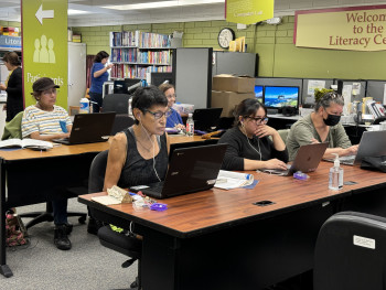 Adult students working on computers in the Literacy Center